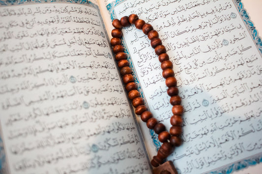 Olive wood prayer beads on Quran